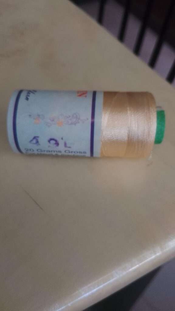 Cream colour silk thread spool code 49L Gold Coin