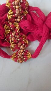 Red thread round om bead rakhi