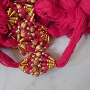 Red thread round om bead rakhi