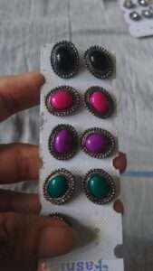 Black metal stud earrings with coloured kundan oval shape