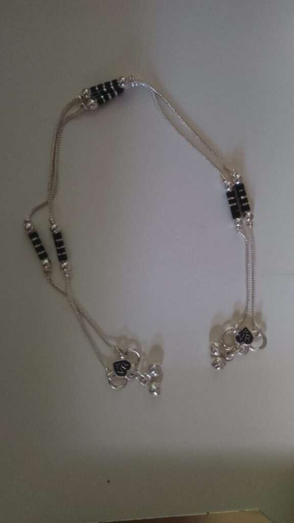 Silver anklets with black beads