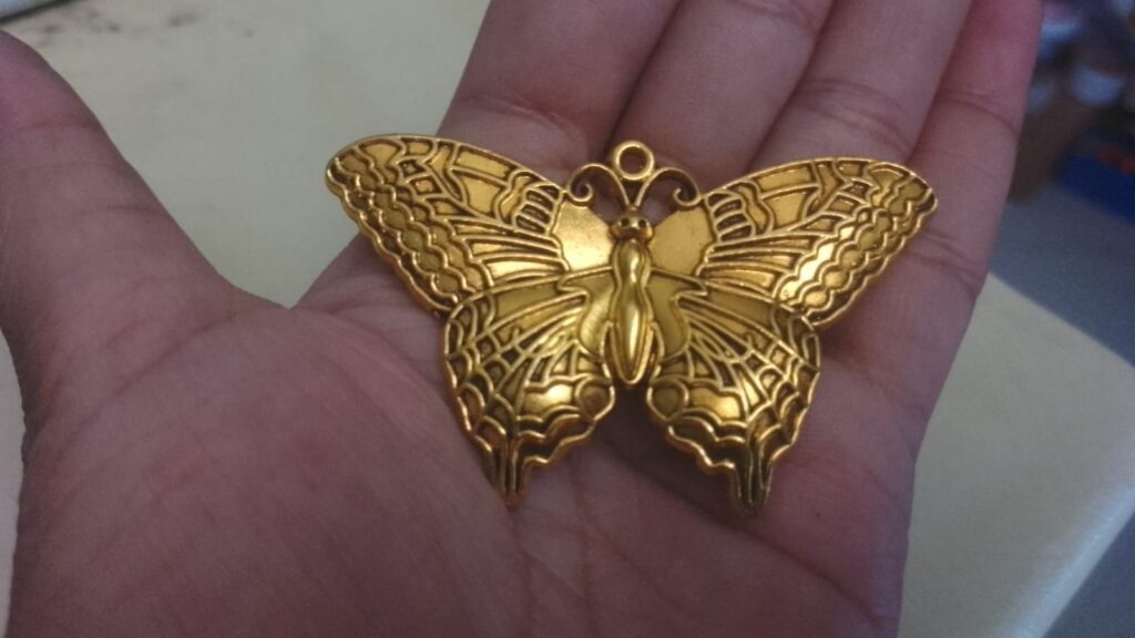 Antique gold butterfly pendant